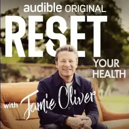 Podcast cover of Jamie Oliver smiling while recording his Audible health podcast “Reset Your Health”